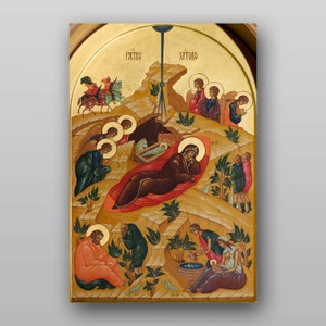 May include: A traditional religious icon depicting the Nativity of Jesus. The icon features a gold background with a central scene of Mary, Joseph, and the baby Jesus in a cave. Angels, shepherds, and other figures surround the central scene. The icon is painted in a realistic style with vibrant colours.