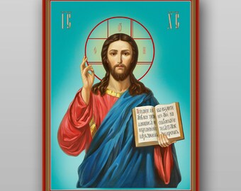 May include: A religious icon painting of Jesus Christ holding a book with text in a foreign language. The painting is framed in a red and gold frame. The background is a light blue colour.