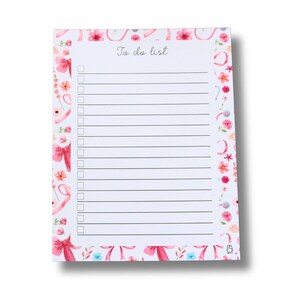 May include: A floral To Do List notepad with a white background. The notepad features pink bows, flowers, and the words "To do list" in cursive. The notepad has a series of lines for writing and check boxes.