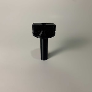 May include: Black plastic knob with a threaded shaft. The knob has a four-way design with a hole in the center.