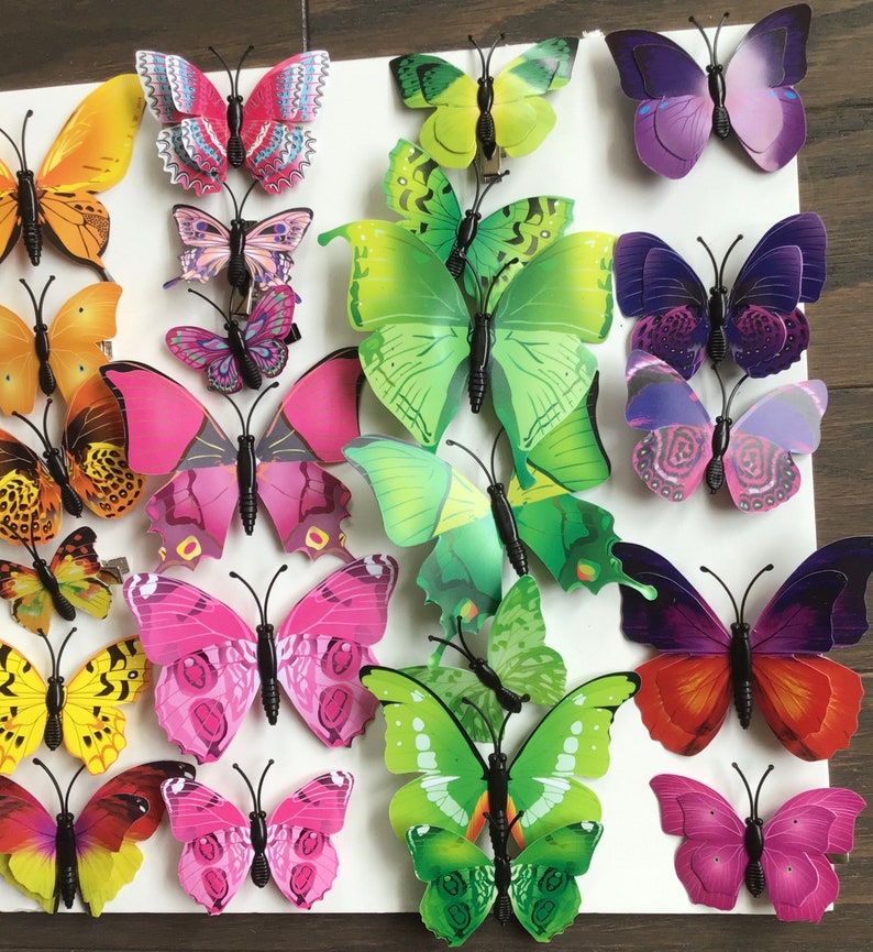 May include: A collection of colorful butterfly wall decor. The butterflies are made of plastic and have a 3D effect. They are perfect for adding a touch of whimsy to any room.