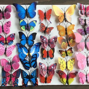 May include: A collection of 3D butterfly wall decor in various colors, including purple, pink, blue, green, orange, and yellow. The butterflies are made of a lightweight material and have a 3D effect, making them appear to be flying.