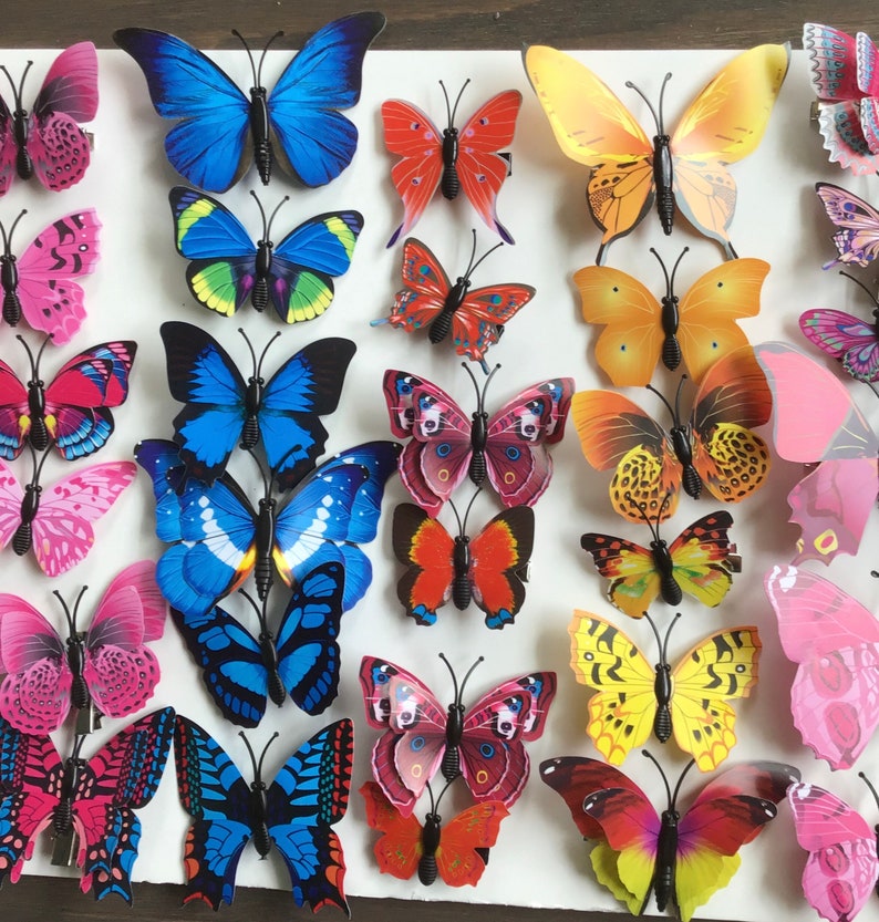 May include: A collection of 30 colorful butterfly-shaped hair clips. The clips are made of plastic and have a variety of designs, including butterflies with polka dots, stripes, and floral patterns. The clips are perfect for adding a touch of whimsy to any hairstyle.