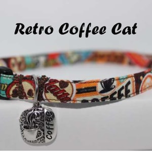 May include: A colorful cat collar with a retro coffee theme. The collar is made of fabric and has a black buckle. It features a silver charm with a coffee cup and the word "Coffee".