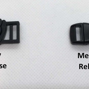 May include: Two black plastic buckles, one with a cat design and the text "Easy Release" and the other with the text "Medium Release".