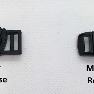 May include: Two black plastic buckles, one with a cat design and the text "Easy Release" and the other with the text "Medium Release".