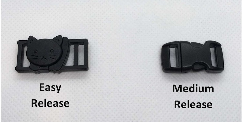 May include: Two black plastic buckles, one with a cat design and the text "Easy Release" and the other with the text "Medium Release".