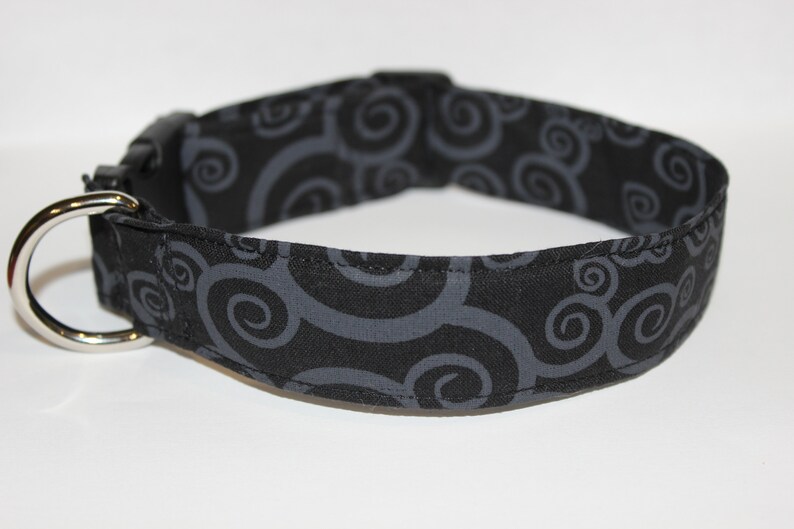 May include: Black dog collar with a gray swirl pattern.