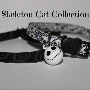 May include: Two cat collars with a black and white patterned design. One collar has a black cat charm and the other has a white Jack Skellington charm. The collars are labeled "Skeleton Cat Collection".