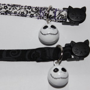 May include: Two black cat collars with a white Jack Skellington bell charm. The collars are made of black and white patterned fabric.