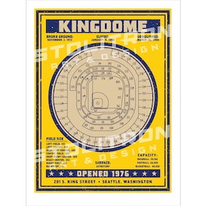 May include: A vintage-style illustration of the Kingdome stadium in Seattle, Washington. The illustration is in blue and yellow colors and shows the seating chart of the stadium. The text "KINGDOME" is at the top of the illustration. The text "BROKE GROUND, NOVEMBER 2, 1972" is below the stadium name. The text "CLOSED, JANUARY 18, 2000" is below the "BROKE GROUND" text. The text "DEMOLISHED, MARCH 26, 2000" is below the "CLOSED" text. The text "OPENED 1976" is at the bottom of the illustration. The text "201 S. KING STREET - SEATTLE, WASHINGTON" is below the "OPENED 1976" text.