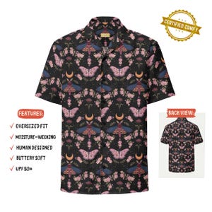 May include: A short-sleeve button-down shirt in black featuring a repeating pattern of pink and blue moths, crescent moons, and small floral sprigs. The shirt has a notched collar and a front button closure. A small inset shows the back view.