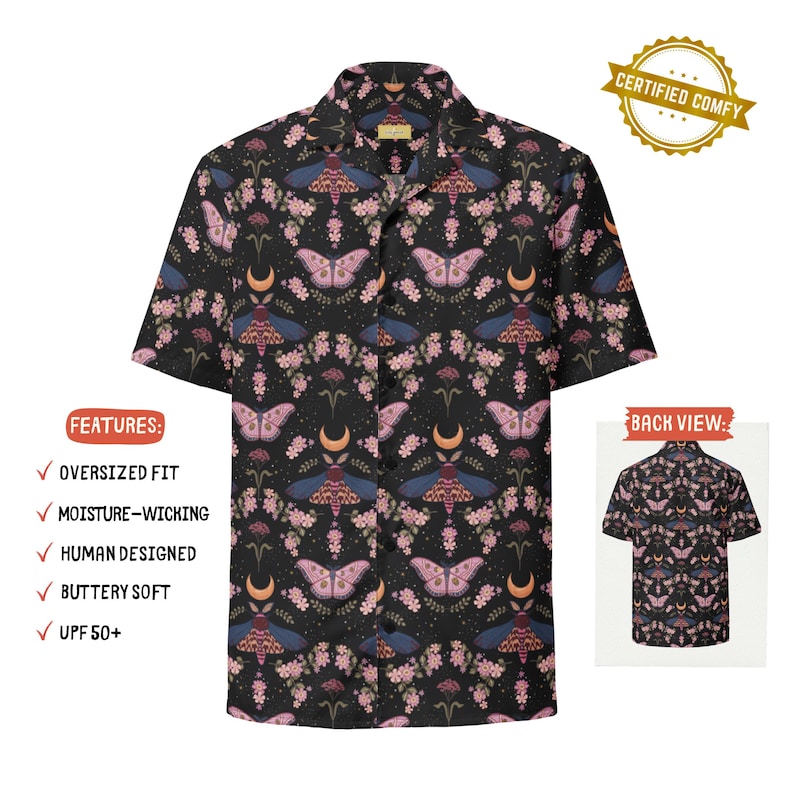 May include: A short-sleeve button-down shirt in black featuring a repeating pattern of pink and blue moths, crescent moons, and small floral sprigs. The shirt has a notched collar and a front button closure. A small inset shows the back view.