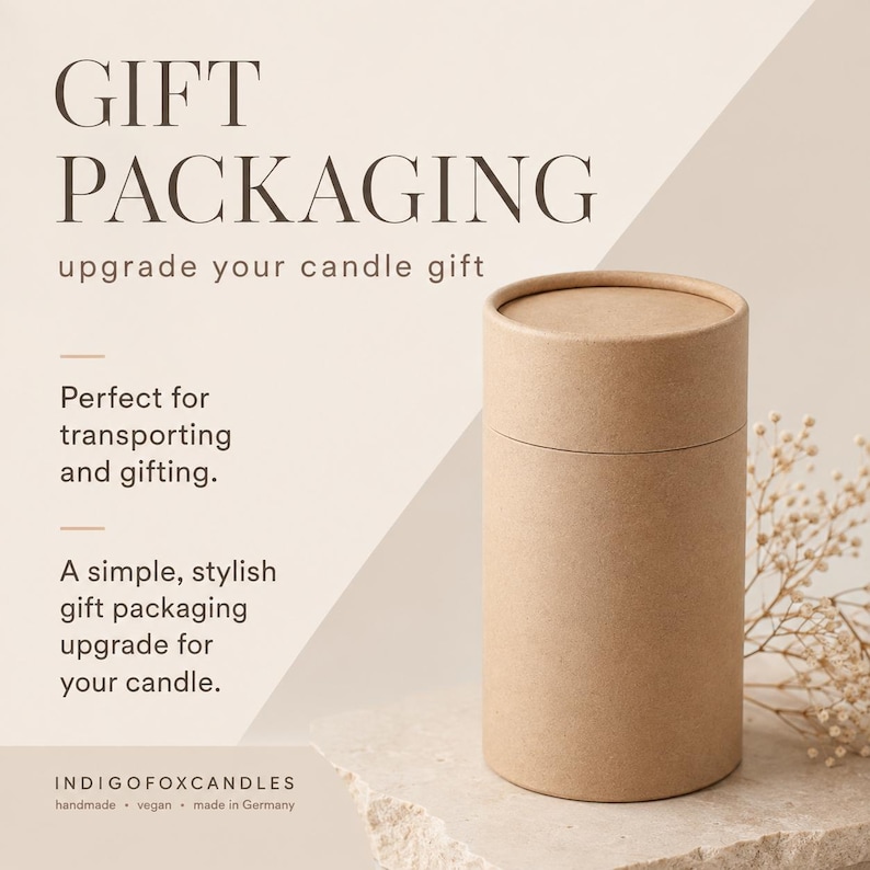 May include: A cylindrical brown cardboard gift tube with a matching lid. The text reads: GIFT PACKAGING, upgrade your candle gift, Perfect for transporting and gifting. A simple, stylish gift packaging upgrade for your candle. INDIGOFOXCANDLES handmade vegan made in Germany.