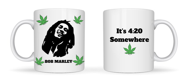 May include: White ceramic mug featuring a black silhouette of Bob Marley, surrounded by green cannabis leaves. The mug also displays the text "BOB MARLEY" and "It's 4:20 Somewhere" with a cannabis leaf graphic.