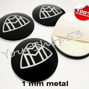 May include: Four black and white car emblems with a geometric design. The emblems are 1 mm metal and have adhesive backing. 100% Guarantee.