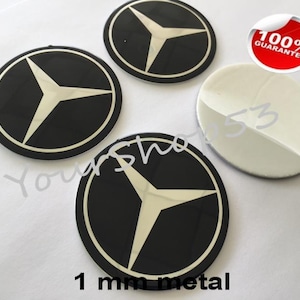 Puede incluir: Cuatro emblemas de coche de metal negro y plateado con un diseño de estrella de tres puntas. Los emblemas tienen un grosor de 1 mm y tienen una garantía del 100%.