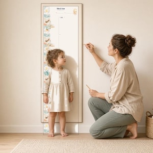 May include: A vertical wall-mounted growth chart featuring a light-colored frame and a white background with colorful illustrations of animals and plants along the left side. The chart includes the text "Kids & Co." at the top and measurement markings.