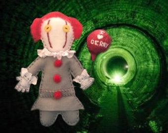 May include: A handmade felt doll of Pennywise the Dancing Clown from the movie "IT". The doll is wearing a red and white clown costume and has a red balloon that says "I ♥ Derry".