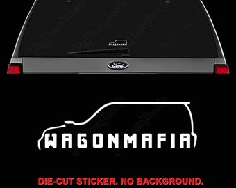 May include: White die-cut sticker with the text "WAGONMAFIA" in bold, block letters. The sticker features a side profile outline of a vehicle. The Ford logo is visible on the vehicle. The sticker is designed to be applied without a background.