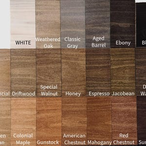 May include: A color chart displaying various wood stain colors. The chart includes shades such as White, Weathered Oak, Classic Gray, Aged Barrel, Ebony, and Black. Additional colors include Provincial Driftwood, Special Walnut, Honey, Espresso, Jacobean, and Dark Walnut. The chart also shows Golden Pecan, Colonial Maple, Gunstock, American Chestnut, Red Chestnut, Mahogany, and Sumatra.