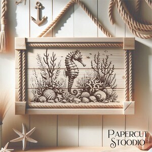 May include: A wooden sign with a rope frame, featuring a hand-drawn illustration of a seahorse surrounded by coral and seashells. The sign is labeled "PAPERCUT STOODIO".