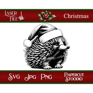 May include: Black and white illustration of an echidna wearing a Santa hat. The image includes the text "Christmas", "SVG JPG PNG", and "Laser File". The image is from Papercut Stoodio.