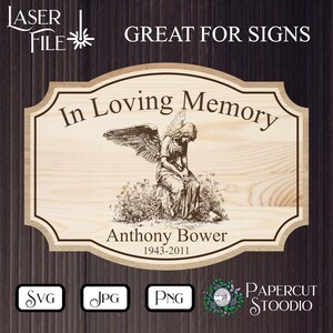 May include: A wooden sign with a distressed wood background featuring a black and white illustration of an angel with wings. The sign reads "In Loving Memory" and "Anthony Bower 1943-2011".