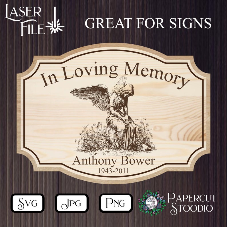 May include: A wooden sign with a distressed wood background featuring a black and white illustration of an angel with wings. The sign reads "In Loving Memory" and "Anthony Bower 1943-2011".
