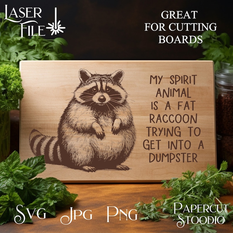 May include: A wooden cutting board with a black and white illustration of a raccoon. The text on the board reads "My spirit animal is a fat raccoon trying to get into a dumpster."