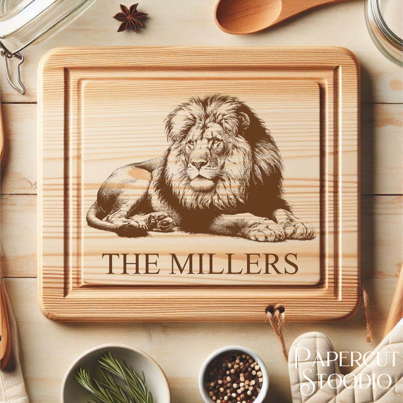 May include: A personalized wooden cutting board with a laser engraved image of a lion and the text "THE MILLERS".