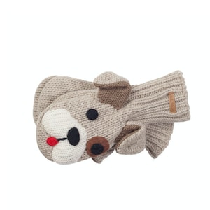 May include: Beige knitted mitten with a brown and white dog face design. The dog has a black nose, brown eyes, and a red tongue.