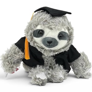 May include: A plush gray sloth wearing a black graduation cap and gown with an orange tassel. The sloth has a white face, large black eyes, and a small black nose. The plush toy is designed to look like a graduate.
