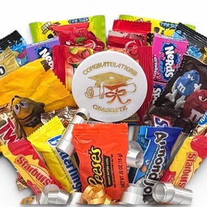 May include: A graduation-themed gift basket filled with assorted candies, including Haribo, Twix, Starburst, Reese's, and Nerds. A white button with gold text that reads "Congratulations Graduate" is in the center.