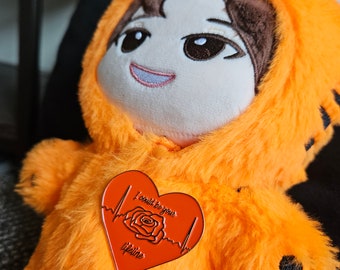 May include: Orange plush toy wearing a tiger costume with a red heart-shaped pin that says "I could be your lifeline" with a rose and a heartbeat graphic.