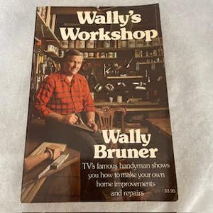 May include: A book cover featuring a man in a red plaid shirt seated in a workshop. The title "Wally's Workshop" is at the top, with "Wally Bruner" below. Text below states "TV's famous handyman shows you how to make your own home improvements and repairs."