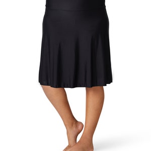 May include: A black, knee-length, A-line skirt with a wide waistband.