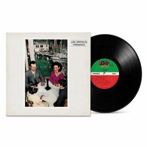 May include: A Led Zeppelin Presence vinyl record and its square cardboard sleeve. The sleeve features a photograph of a family sitting at a table with a black object, with a marina in the background. The record has a green and red Atlantic label.