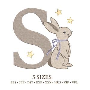 May include: An embroidered design featuring a tan letter "S" with a light brown bunny wearing a blue bow. Three yellow stars are scattered around the bunny. The text "5 SIZES" is below the design.