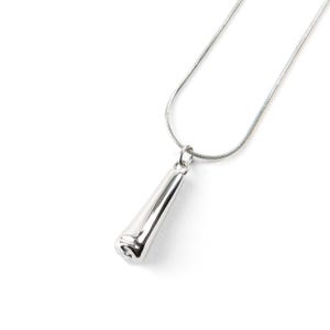 May include: A silver chain necklace with a long, thin, silver pendant shaped like a pointed, rounded, cylinder.