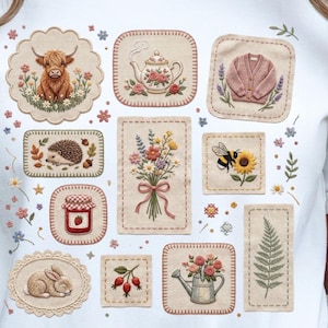 May include: A white t-shirt adorned with embroidered patches featuring various nature-inspired designs. These include a Highland cow, teapot, pink cardigan, hedgehog, bouquet of flowers, bee on a sunflower, jar of jam, bunny, rose hip sprig, watering can, and fern.