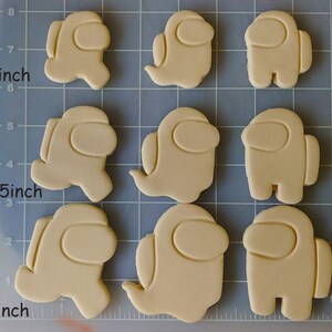 May include: Nine cookie cutters in the shape of the popular video game character Among Us. The cutters are 2.5 inches and 3 inches in size.