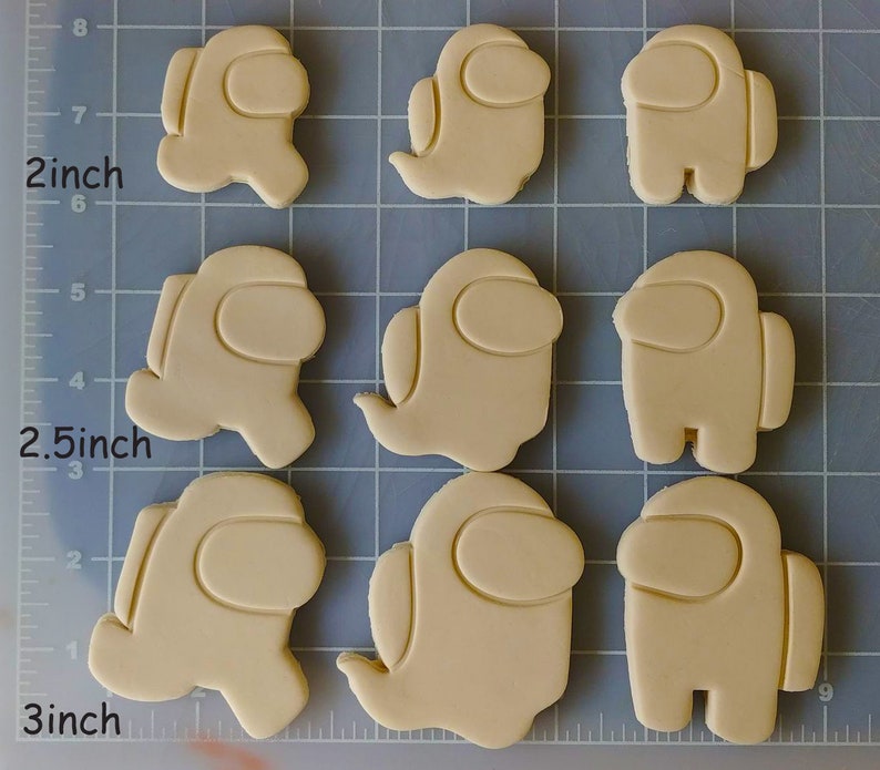 May include: Nine cookie cutters in the shape of the popular video game character Among Us. The cutters are 2.5 inches and 3 inches in size.
