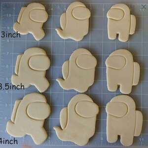 May include: Nine cookie cutters in various sizes, shaped like the character from the video game Among Us. The cutters are 3 inches, 3.5 inches, and 4 inches in size.