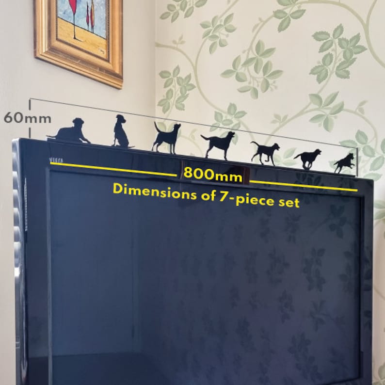 May include: Black silhouette of seven dogs in various poses, arranged in a line on a black television screen. The dogs are 60mm tall and the set is 800mm wide. The text "Dimensions of 7-piece set" is below the dogs.