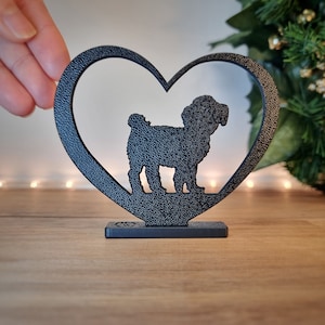 May include: Black metal heart-shaped silhouette of a dog, standing on a black base.