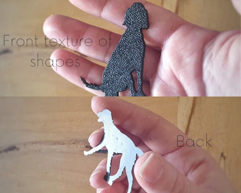 May include: A black dog silhouette cutout with a textured front and a smooth back.