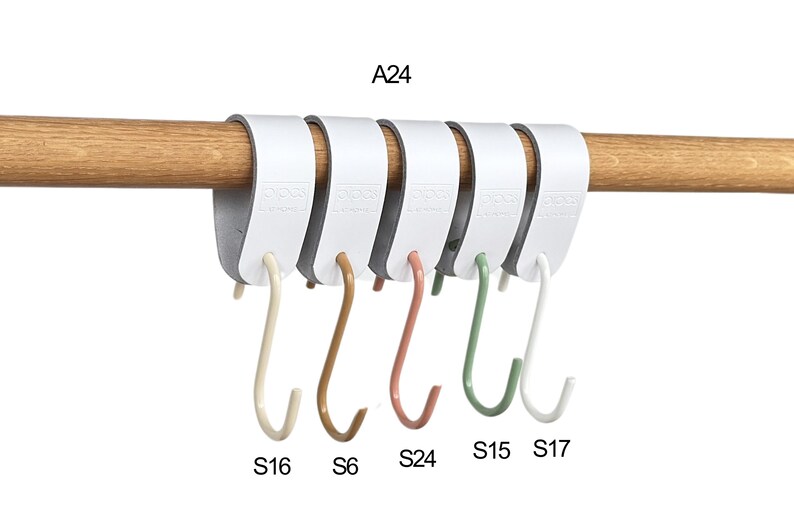 May include: A white, multi-hook organizer with five S-shaped hooks in various colors: beige, brown, coral, green, and white. The organizer is attached to a wooden rod. Text on the organizer reads "A24", and the hooks are labeled "S16", "S6", "S24", "S15", and "S17".