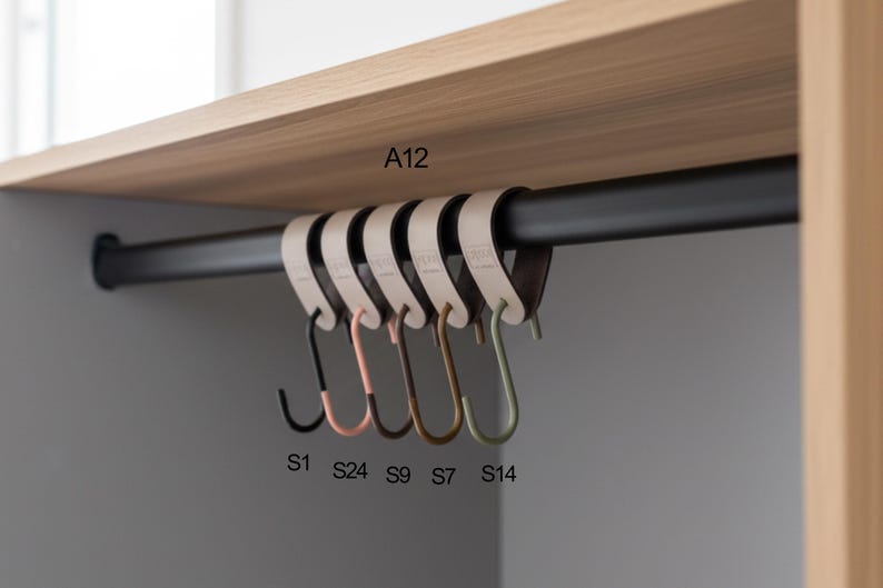 May include: A set of six S-shaped hooks in various colors, hanging from a black rod. The hooks are black, pink, brown, and green. The hooks are labeled S1, S24, S9, S7, and S14. The hooks are hanging under a wooden shelf.