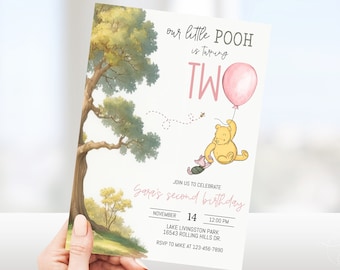 May include: A Winnie the Pooh themed birthday invitation with a pink balloon, Winnie the Pooh holding a balloon, and Piglet. The invitation says "our little POOH is turning TWO" and "Join us to celebrate Gopi's second birthday". The invitation includes the date, time, location, and RSVP information.